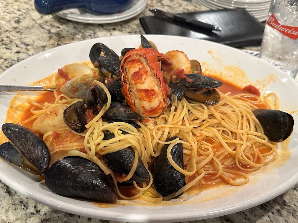 Plates of pasta on a restaurant table.